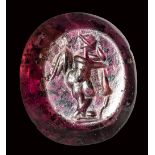 A roman garnet intaglio. Eros with a torch.3rd century A.D.