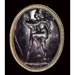 A dark purple glass impression set in gilted metal fob seal. Hermaphrodite and Salmace.