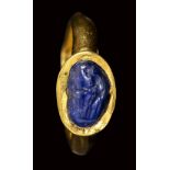 A rare late hellenistic sapphire intaglio set in a later gold ring. Venus at the fountain. 2nd - 1
