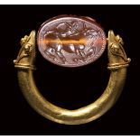 An etruscan carnelian engraved scarab set in a gold swivel ring. Europa with Zeus as bull.La