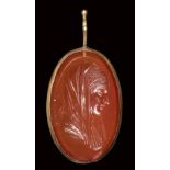 A neoclassical carnelian intaglio set in a gold devotional pendant. Madonna with emblema. 19