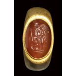 A roman gold ring with carnelian intaglio. Eros with weapons. 1st - 2nd century A.D.
