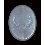 A fine late classical greek blue chalcedony scaraboid seal. Two molossian dogs.5th century B