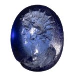 A roman blue glass intaglio. Portrait of Helios. 2nd century A.D.