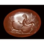 A roman carnelian intaglio. Griffin with deer.2nd - 3rd century A.D.