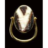 A large roman italic banded agate intaglio set in a swivel gold ring. Sacrifice to Artemis.
