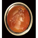 A neoclassical carnelian intaglio set in a modern ring. Bust of a Bacchante. 19th century.