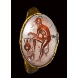 A roman carnelian intaglio set in a gold ring. Heraclides attempting a draw.1st century A.D.