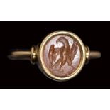 A roman carnelian intaglio set in a gold ring. Eagle. 2nd - 3rd century A.D.