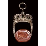 A late italic carnelian engraved scarab set in a 19th century gold mounting. Head of Ulysses.