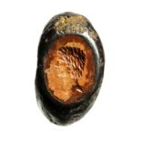 A roman imperial burnt jasper intaglio set in an iron ring. Male bust. Late 2nd century A.D.