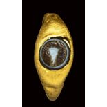 A roman gold ring set with a three-layered agate intaglio. bucrane. 1st - 2nd century A.D.