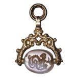 A greek classical banded agate scaraboid engraved seal set in a gold swivel mounting. Scylla.