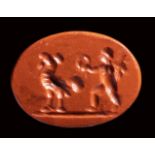 A roman red jasper intaglio. Winged eros with rooster. 1st - 2nd century A.D.