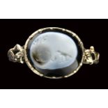 A rare nicolo agate intaglio set in a gold ring. Allegorical scene with animals. 1st - 2nd c