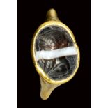 A late hellenistic gold ring set with a banded agate intaglio. Bust of Herm.2nd century B.C