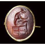 A fine greek agate intaglio set in a gold brooch. Scene of Toilette.5th century B.C.