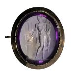 A fine amethyst neoclassical intaglio set in a gold brooch. Apollo playing lyra.First half o