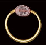 A rare small Phoenician carnelian scarab set in a gold swivel ring. Lion head.6th century B