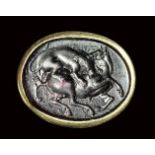 A dark purple glass impression set in a signet gold ring. Lion with an horse. 19th century.