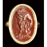 A fine neoclassical carnelian intaglio set in a modern gold ring. Hercules fighting the Nemean Lion.