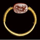 An etruscan carnelian scarab intaglio set in a gold swivel ring. Bull. 3rd century B.C.