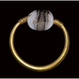 An etruscan banded agate engraved scarab set in a gold swivel ring. Sea-horse.