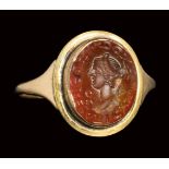 A roman carnelian intaglio set in a later gold ring. Bust of a Matrona with inscription.2nd