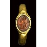 A roman carnelian intaglio set in a gold ring. Allegorical emblema. 2nd century A.D.