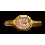 A roman burnt agate intaglio set in a gold ring. Pegasus.2nd century A.D.