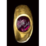 A roman gold ring set with a garnet cabochon intaglio. Butterfly metamorphosis.1st century B
