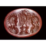 A roman carnelian intaglio. Two private portraits as Helios and Selene, with an eagle.End of