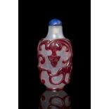 A RED OVERLAY ‘CHI DRAGON’ GLASS SNUFFBOTTLE China, Modern Sold together with a blue stopper.