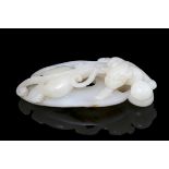 A WHITE JADE MODEL OF A ‘CHI DRAGON’ China, Modern L: 8,8 cm Weight: 86,8 grams