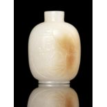 A RUSSETS AND WHITE JADE ‘EROTIC SUBJECT’ SNUFF BOTTLE INSCRIBED WITH TWO VERSES OF A POETRY BY