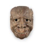 A KYOGEN THEATER MASK OF A CONTORTED CARACTER Japan, Edo to Meiji period A lacquered wooden mask.