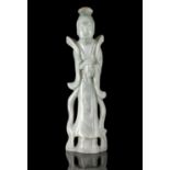 A APPLE GREEN ACCENT MILKY JADEITE CARVING OF A GUANYIN China, Circa 1900 The Goddess of Mercy