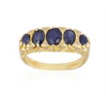 A SAPPHIRE FIVE-STONE DRESS RING, composed of five graduated oval-shaped sapphires with foliate