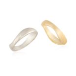 TWO GOLD RINGS BY CARTIER, of wavy design, one in 18K white gold, and the other in 18K yellow gold,