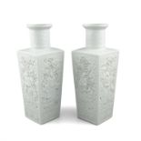 A PAIR OF CHINESE BLANC DE CHINE SQUARE SECTION VASES, (formerly lamped) each side decorated in