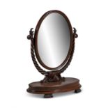 A VICTORIAN MAHOGANY DRESSING TABLE MIRROR, the oval glass plate supported by rope twist upright