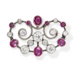 AN EARLY 20TH CENTURY RUBY AND DIAMOND BROOCH, the openwork brooch with scrolling detailing set