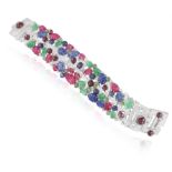 A GEM-SET AND DIAMOND BRACELET, of 'tutti frutti' design, the wide strap set with carved ruby,