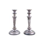 A PAIR OF SILVER PLATED TABLE CANDLESTICKS, of circular form, with gadroon decoration and raised on