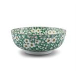 A CHINESE 19TH CENTURY PRUNUS PATTERN BOWL, painted in green and yellow enamels with four-