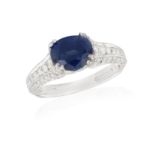 A SAPPHIRE AND DIAMOND DRESS RING, the oval-shaped sapphire weighing approximately 1.