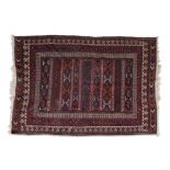 A FLAT WOVEN AFSHAR WOOL CARPET, 20TH CENTURY, of rectangular shape, the central field woven with