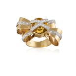 A CITRINE AND DIAMOND COCKTAIL RING, designed as a ribbon bow centring an oval-shaped citrine