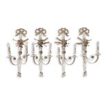 A SET OF FOUR REGENCY STYLE CREAM PAINTED AND GILT TWO-LIGHT WALL SCONCES, with tied ribbons,