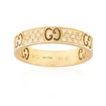 A DIAMOND RING BY GUCCI, the band engraved with 'Gucci' alternated with brilliant-cut diamonds,
